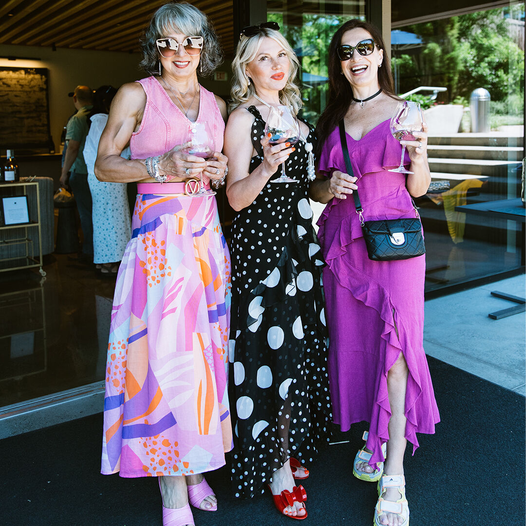 3 women holding wine glasses outside WillaKenzie Estate tasting room